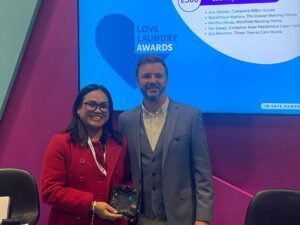 WASHCO CEO presents laundry hero award to winner