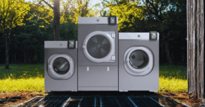 WASHCONNECT washing machines and dryers in a nature setting. Trees in the background and earth beneath them.